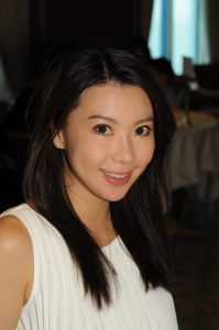 photo a Eliza: an Asian woman with shoulder length jet black hair wearing a white shirt