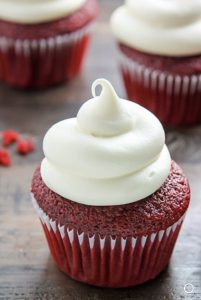 photo of red velvet cupcake with white swirly frosting